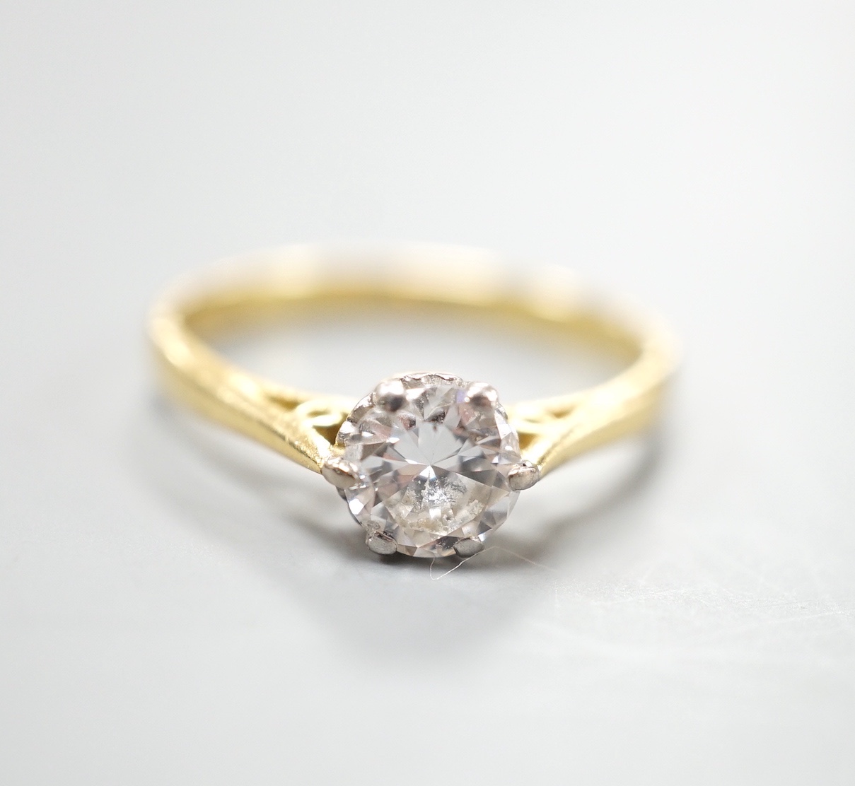 A modern 18ct gold and solitaire diamond ring, size O, gross weight 3 grams